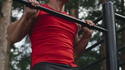 Man Doing Pull-Ups at Outdoor Gym