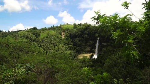 Tropical Waterfall Landscape Under Blue Cloudy Sky