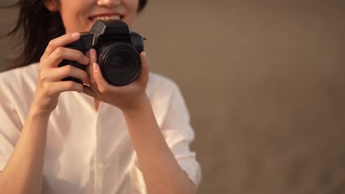 Smiling Woman Taking a Photo with Camera