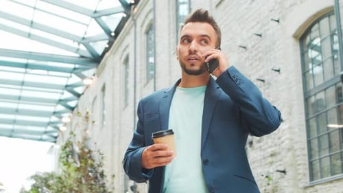 Young successful caucasian businessman works outdoor