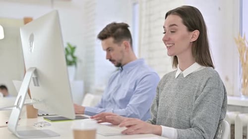 Creative Woman Doing Video Chat on Desktop in Office