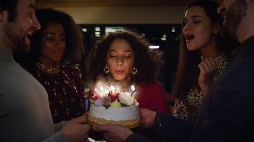 Happy Woman Blowing Candles on Birthday Cake at Friends Celebration Cafe Party