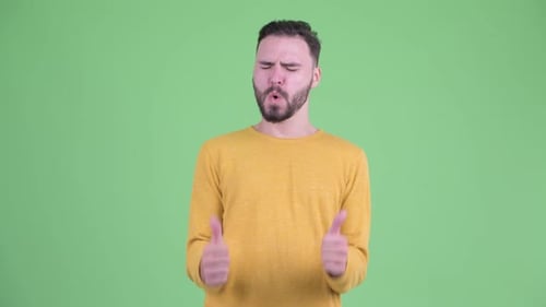 Smiling Man Gives a Thumbs Up Gesture