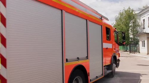 Fire Engine Drives Slowly in Urban Environment