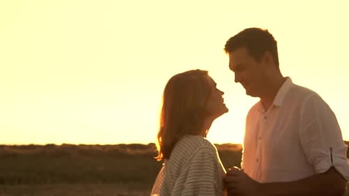 Romantic Couple Kissing at Sunset on the Beach
