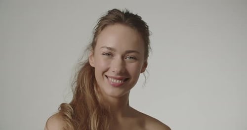 Smiling Young Woman Posing Naturally in Studio