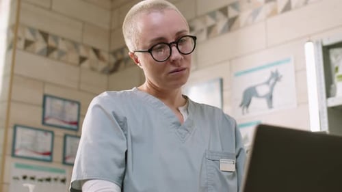 Female Veterinarian Using Laptop in Clinic