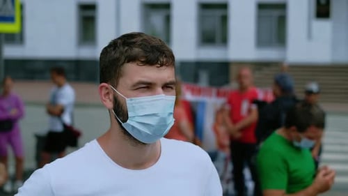 Person wearing a face mask in urban area