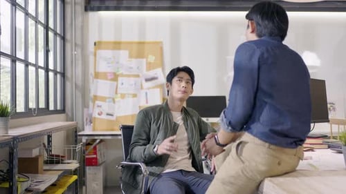 Two Men Discussing in Office Workplace Setting