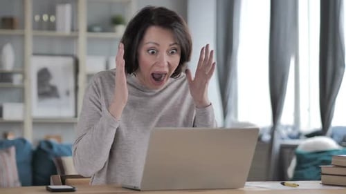 Surprised Woman Reacts to Laptop in Home
