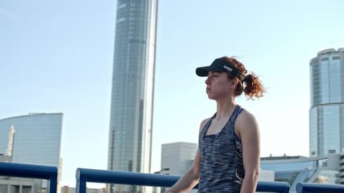 Athletic Woman Drinks Water After Urban Run