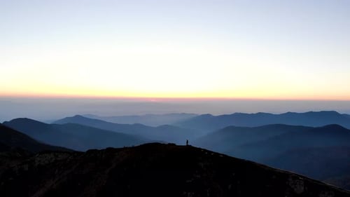 Aerial Flying Above Mountain With Man Hiker Walking On It