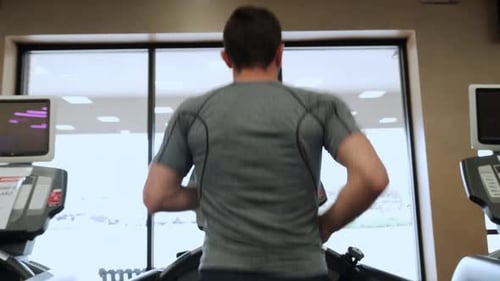 Man Walking on Running Track Warming Up on Gym Treadmill