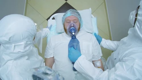 Medical Staff Assisting Patient with Oxygen Mask