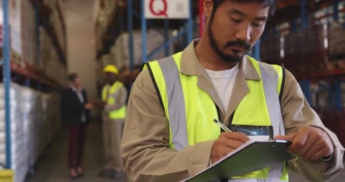 Young man working in a warehouse 4k