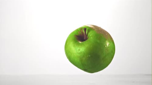Super Slow Motion Fresh Apple Falls Into the Water with Splashes