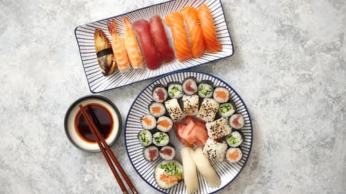 Asian Food Assortment. Various Sushi Rolls Placed on Ceramic Plates