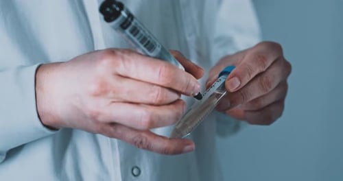 Scientist Labels Test Tube, Extracts and Dispenses Samples