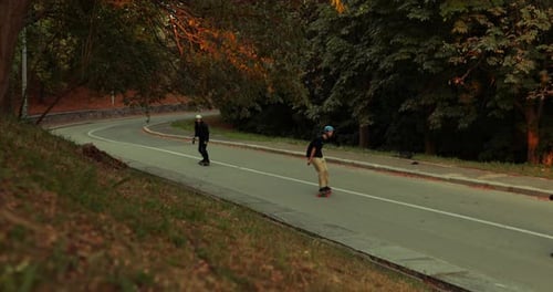 A Group of Guys Go Down the Slope on Skates.