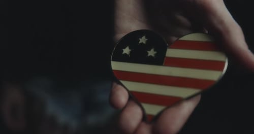 Hand Holding Heart Shaped American Flag Ornament