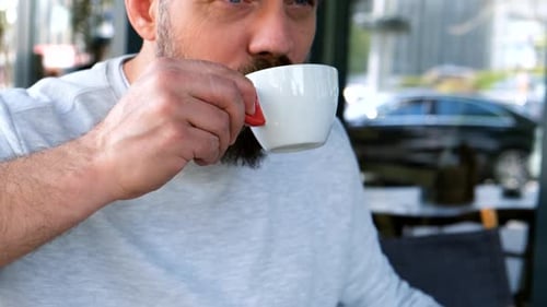 Handsome Bearded Man Drinking a Cup of Coffee