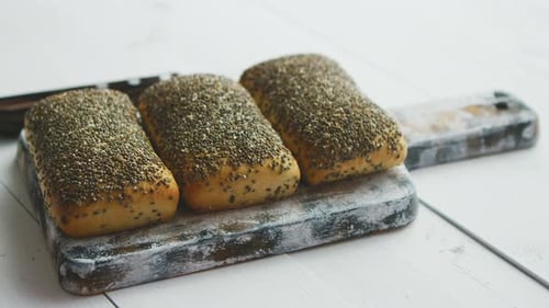 Delicious Seeded Bread Rolls on Rustic Cutting Board