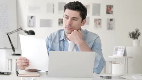 Casual Young Man Reading Documents