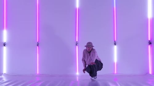 Dancing Man Young Talented Street Dancer Performing Freestyle Hip Hop Moves Against Bright Neon