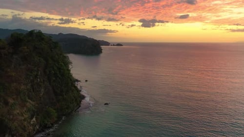 Flying Above a Rainforest Coastline of Costa Rica at Sunset