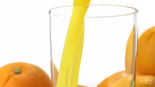 Orange Juice Pours into a Glass
