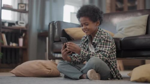 Boy Using Smartphone for Video Call at Home