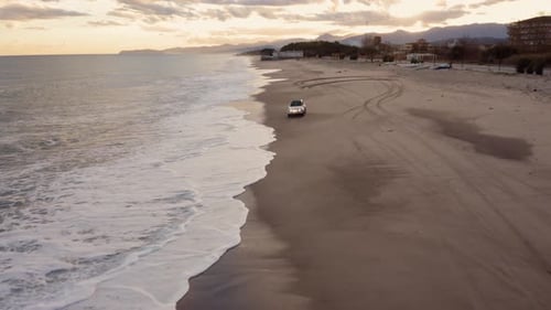 Vehicle off road splash into the wave on the beach