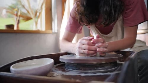 Female Potter Working with Pottery Wheel