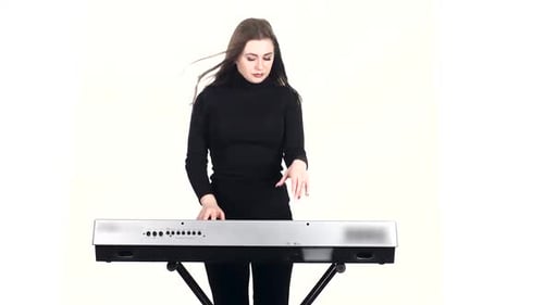 Woman Plays Digital Piano and Sings on White Background