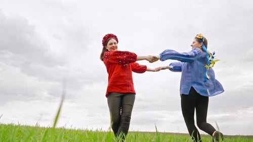 Happy Ukrainian Women Rotating Dancing Playing and Holding Hands in Green Field