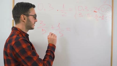 Man Writing Math Equations on Whiteboard