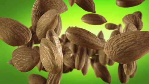 Flying of Almonds in Green Background