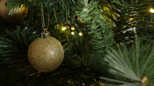 Golden color Christmas ornament close-up 4K 2160p 30fps UltraHD footage - Shiny fairy-lights and bau
