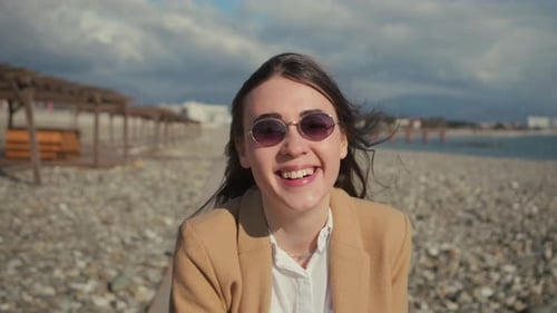 Funny Woman Is Smiling Broadly at Camera, Catching Hat From Hard Wind, Portrait