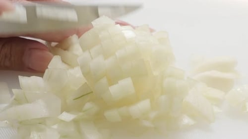 Common bulb onion chopping up with knife 4K 2160p 30fps UHD footage - Close-up Allium cepa vegetable