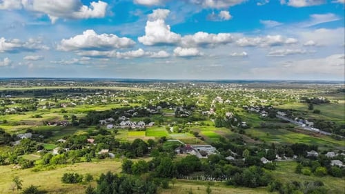 Hyperlapse of Village and Small Houses with Moving Clouds in Sky From a Flying Drone