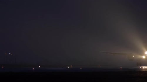 Slow Video As a Passenger Plane Takes Off From the Airport Runway at Night