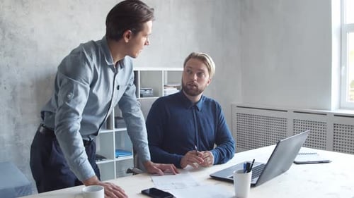 Two business persons are work together in modern office. Team of businessmen.