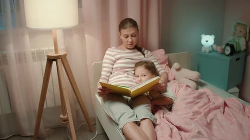 Mother Reading Bedtime Story to Child at Night