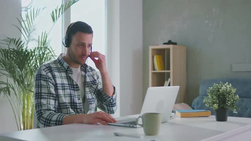 Man Working on Laptop at Home Office Desk