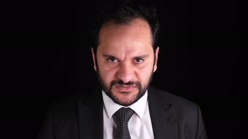 Furious Man in Suit Stares Intensely