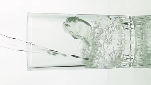 Clear Liquid Fills a Glass with Bubbles