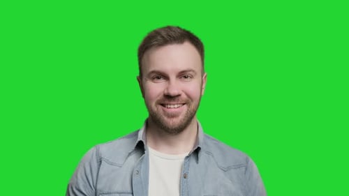 Hübscher Mann lächelt und schaut in die Kamera. Porträt von Guy auf Green Screen