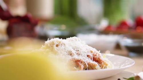 Plating Pasta Dish with Grated Parmesan Cheese