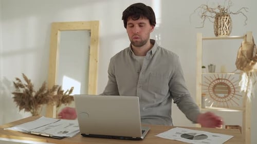 Man Meditating at Desk, Relaxing from Work